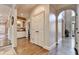 Hallway featuring wood floors and an arched entrance with views of a room with decorative cabinetry at 10355 Oxford Mill Cir, Johns Creek, GA 30022