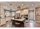 Bright kitchen features a spacious island with bar seating, stainless steel appliances, and lots of natural light at 10355 Oxford Mill Cir, Johns Creek, GA 30022