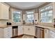 Kitchen area showcases stainless steel appliances and granite countertops, with ample natural light at 10355 Oxford Mill Cir, Johns Creek, GA 30022