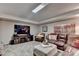 Cozy living room showcases a leather sectional sofa, fireplace, and a large screen tv for entertainment at 10355 Oxford Mill Cir, Johns Creek, GA 30022