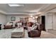 Cozy living room showcases a leather sectional sofa, with carpet flooring and neutral decor at 10355 Oxford Mill Cir, Johns Creek, GA 30022