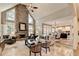 Spacious living room featuring a stone fireplace, high ceilings, and open floor plan at 10355 Oxford Mill Cir, Johns Creek, GA 30022