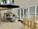 Private patio featuring an outdoor dining set, grill, and manicured garden offers serene outdoor living at 10355 Oxford Mill Cir, Johns Creek, GA 30022