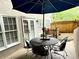 Charming patio with stylish outdoor furniture and a large umbrella for shade, perfect for relaxing at 10355 Oxford Mill Cir, Johns Creek, GA 30022