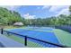 Well-maintained tennis courts surrounded by trees, providing an active recreational option for residents at 10355 Oxford Mill Cir, Johns Creek, GA 30022