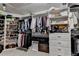 Spacious walk-in closet with custom shelving, hanging racks, drawers and plenty of storage for organization at 10355 Oxford Mill Cir, Johns Creek, GA 30022