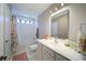 Cozy bathroom with a shower-tub combination, floral curtain and a large vanity for ample counter space and storage at 147 Johnston Farm Ln, Woodstock, GA 30188