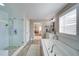 Modern bathroom showcasing a walk-in shower, luxurious soaking tub, and elegant fixtures for a spa-like retreat at 147 Johnston Farm Ln, Woodstock, GA 30188