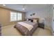 This stylish bedroom features a cozy bed, modern ceiling fan, and a patterned accent wall at 147 Johnston Farm Ln, Woodstock, GA 30188