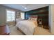 Bright bedroom with a stylish wood-paneled accent wall, offering a cozy and modern feel at 147 Johnston Farm Ln, Woodstock, GA 30188