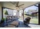Comfortable covered patio offering stylish seating, ceiling fan, and views of the backyard at 147 Johnston Farm Ln, Woodstock, GA 30188
