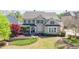 Beautiful two-story home featuring brick facade, covered front porch, and manicured landscaping at 147 Johnston Farm Ln, Woodstock, GA 30188