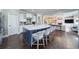 Open-concept kitchen with white cabinets, island seating, and hardwood floors at 147 Johnston Farm Ln, Woodstock, GA 30188