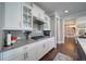 Bright kitchen featuring custom white cabinets, gray backsplash, and stainless steel range hood at 147 Johnston Farm Ln, Woodstock, GA 30188
