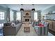 Bright living room featuring fireplace and lots of natural light from the large windows at 147 Johnston Farm Ln, Woodstock, GA 30188