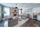 Beautiful living room featuring a fireplace, neutral tones, and large windows with lots of natural light at 147 Johnston Farm Ln, Woodstock, GA 30188