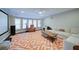 Relaxing living room with plush seating, large windows, and a big screen, perfect for entertainment at 147 Johnston Farm Ln, Woodstock, GA 30188