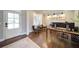 Well-lit home office with hardwood floors, modern desk, and comfortable seating at 147 Johnston Farm Ln, Woodstock, GA 30188