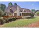 Spacious backyard with a deck, screened porch, and mature trees, perfect for outdoor enjoyment and relaxation at 7700 Dunvegan Close, Atlanta, GA 30350