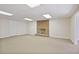 Carpeted basement with a decorative brick fireplace, adding warmth and charm at 7700 Dunvegan Close, Atlanta, GA 30350