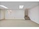 Finished basement area with carpeted floor, access stairs and natural light at 7700 Dunvegan Close, Atlanta, GA 30350