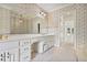 Spacious bathroom with a double vanity, floral wallpaper, large mirror, and carpet flooring at 7700 Dunvegan Close, Atlanta, GA 30350