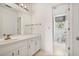 Classic bathroom with white vanity, framed mirror, and a separate toilet room for privacy at 7700 Dunvegan Close, Atlanta, GA 30350