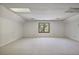 Spacious, carpeted room with a large window offering natural light and outdoor views at 7700 Dunvegan Close, Atlanta, GA 30350