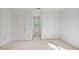 Carpeted bedroom featuring two closets, an accent window, and neutral walls at 7700 Dunvegan Close, Atlanta, GA 30350