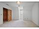 Well-lit bedroom boasts neutral carpet and white paint, creating a clean, welcoming space at 7700 Dunvegan Close, Atlanta, GA 30350