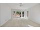 Bright bedroom featuring a ceiling fan and deck access through large windows offering scenic views at 7700 Dunvegan Close, Atlanta, GA 30350