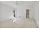 Carpeted bedroom with a ceiling fan, white walls, natural light, and an open doorway at 7700 Dunvegan Close, Atlanta, GA 30350