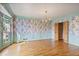Dining room featuring hardwood floors, light blue accents, and floral wallpaper at 7700 Dunvegan Close, Atlanta, GA 30350
