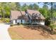 Charming home featuring a welcoming front porch and a well-manicured front yard at 7700 Dunvegan Close, Atlanta, GA 30350