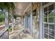 Close-up of a covered front porch featuring stone columns and a stone floor at 7700 Dunvegan Close, Atlanta, GA 30350