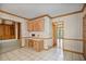 Eat in kitchen with a desk area, light wood cabinets, and white tile flooring at 7700 Dunvegan Close, Atlanta, GA 30350