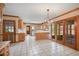 Bright kitchen with white tile floor, light wood cabinets, and glass doors leading to the outside at 7700 Dunvegan Close, Atlanta, GA 30350