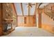 Spacious living room with a stone fireplace, built-in shelving, and hardwood trim at 7700 Dunvegan Close, Atlanta, GA 30350