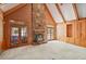 Spacious living room featuring a stone fireplace, built-in shelving, and French doors to a sunroom at 7700 Dunvegan Close, Atlanta, GA 30350