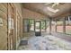 Enclosed sunroom featuring stone flooring, multiple windows and access to outdoors, ideal for relaxation at 7700 Dunvegan Close, Atlanta, GA 30350