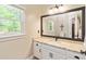 Bathroom features white vanity with granite counters and a large framed mirror at 8518 Shoreview Ct, Jonesboro, GA 30236