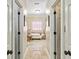Hallway view of an elegant bathroom with a soaking tub and unique stained glass window at 8518 Shoreview Ct, Jonesboro, GA 30236