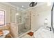 Bathroom featuring tiled walk-in shower, granite countertop, and a decorative stained glass window at 8518 Shoreview Ct, Jonesboro, GA 30236