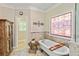 Luxurious bathroom with soaking tub, stone accents, and a decorative stained glass window at 8518 Shoreview Ct, Jonesboro, GA 30236