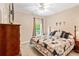 Comfortable bedroom featuring a ceiling fan, patterned bedspread, and neutral colored walls at 8518 Shoreview Ct, Jonesboro, GA 30236