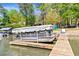 Covered boat docked on a wooden pier, ready for lake adventures at 8518 Shoreview Ct, Jonesboro, GA 30236