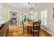Inviting breakfast nook with hardwood floors and an elegant chandelier lighting a round table at 8518 Shoreview Ct, Jonesboro, GA 30236