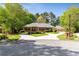 Brick home with a manicured lawn and mature trees, featuring a circular driveway and attached garage at 8518 Shoreview Ct, Jonesboro, GA 30236