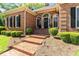 Inviting front entrance with brick steps and decorative landscaping, perfect for curb appeal at 8518 Shoreview Ct, Jonesboro, GA 30236