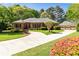 Beautiful brick home with lush landscaping and a curved driveway leading to a detached two-car garage at 8518 Shoreview Ct, Jonesboro, GA 30236
